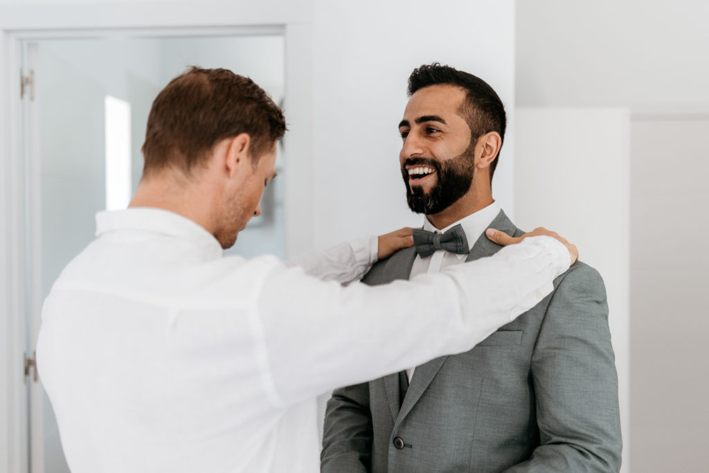 a man adjusting a suit