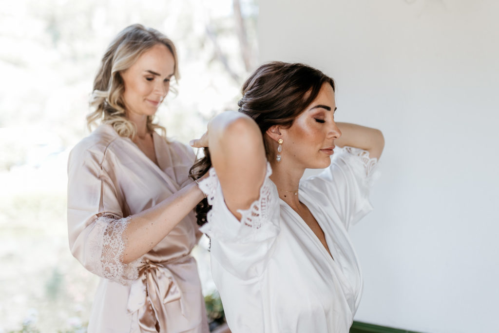 a woman wearing a robe and another woman wearing a white robe