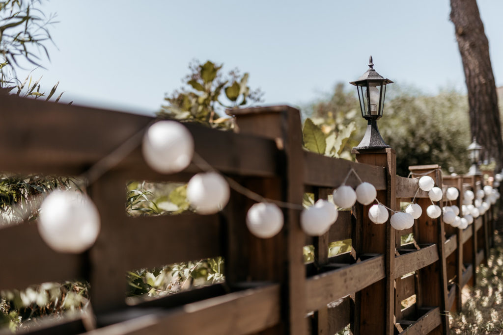 a fence with white balls on it