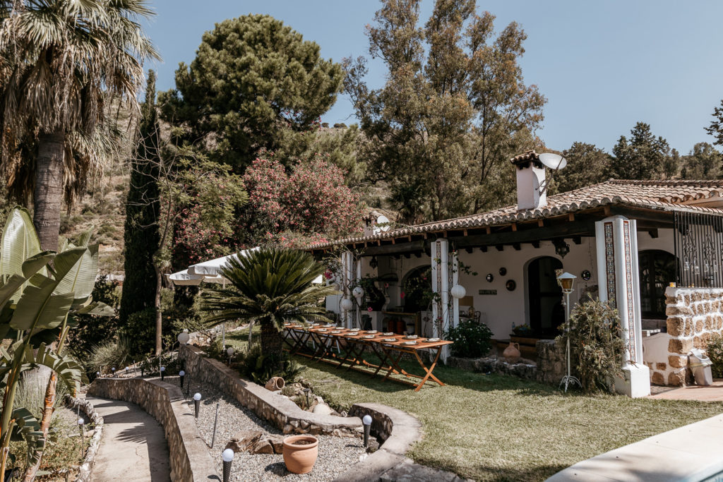 a house with a table and chairs in the yard