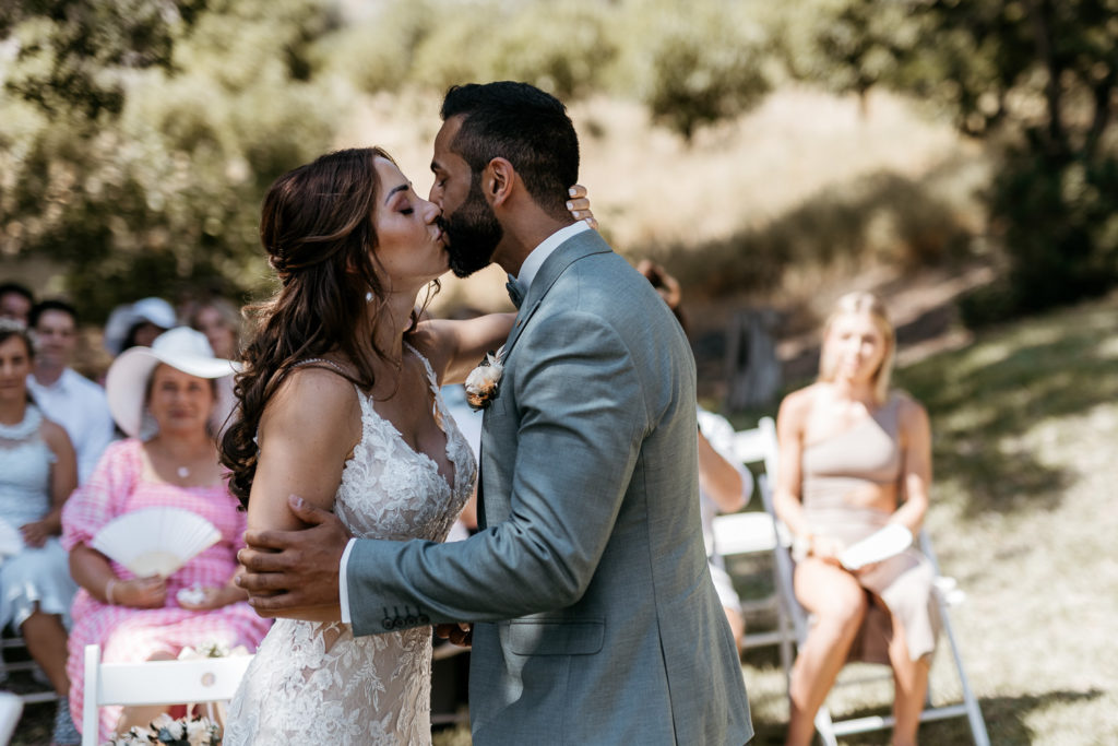 a man and woman kissing outside