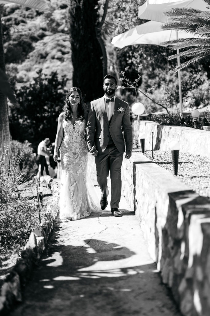 a man and woman walking down a path