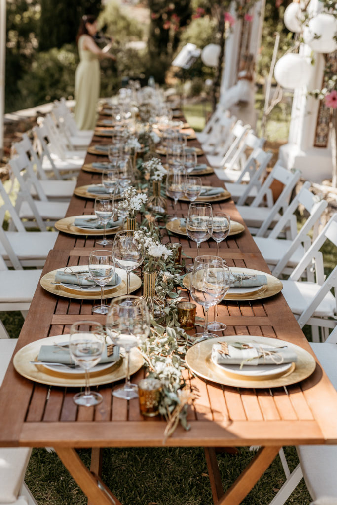 a long table with plates and glasses on it