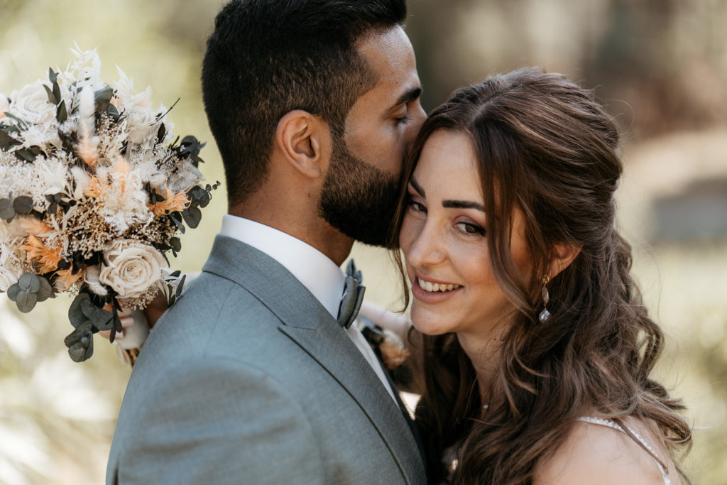 a man kissing a woman's cheek