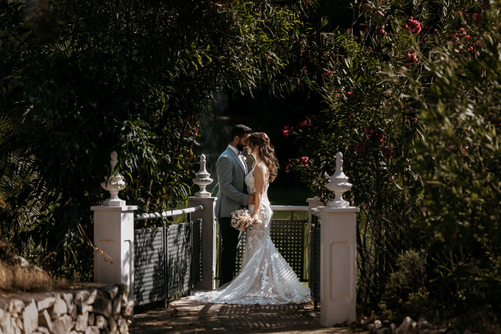 a man and woman kissing on a bridge