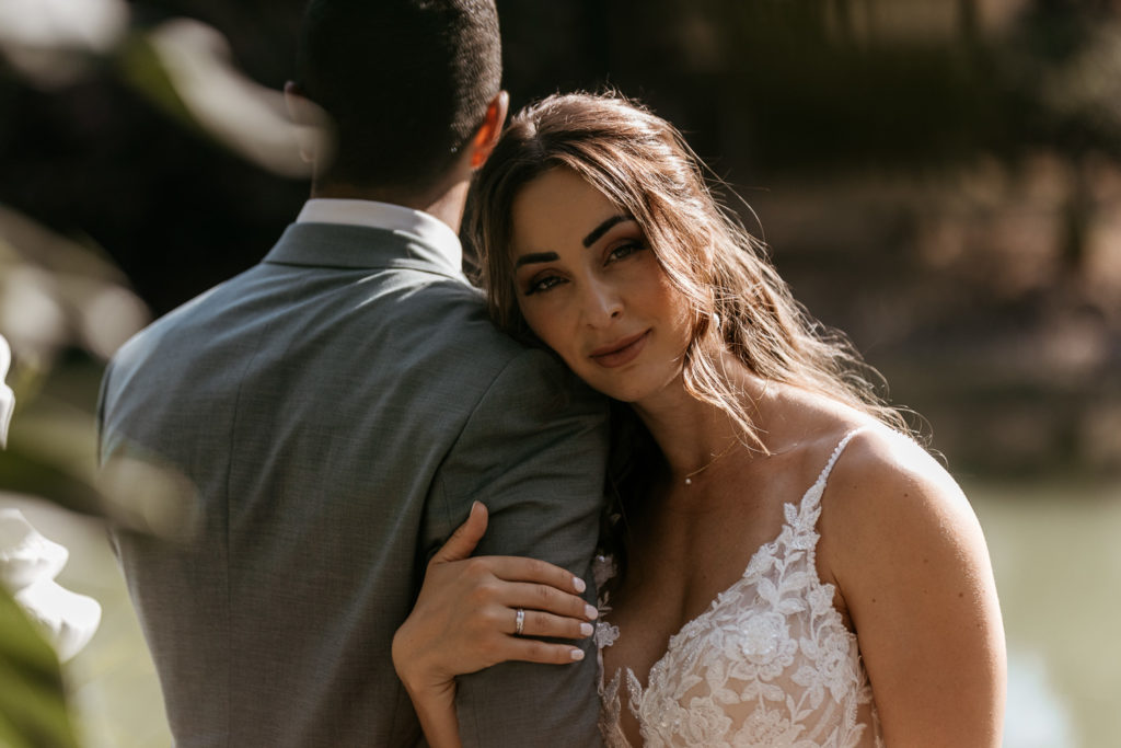 a woman in a white dress hugging a man