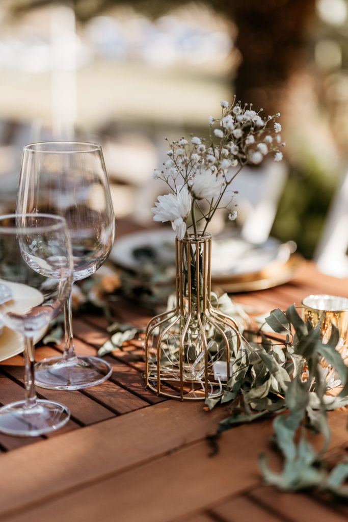 a table with wine glasses and flowers