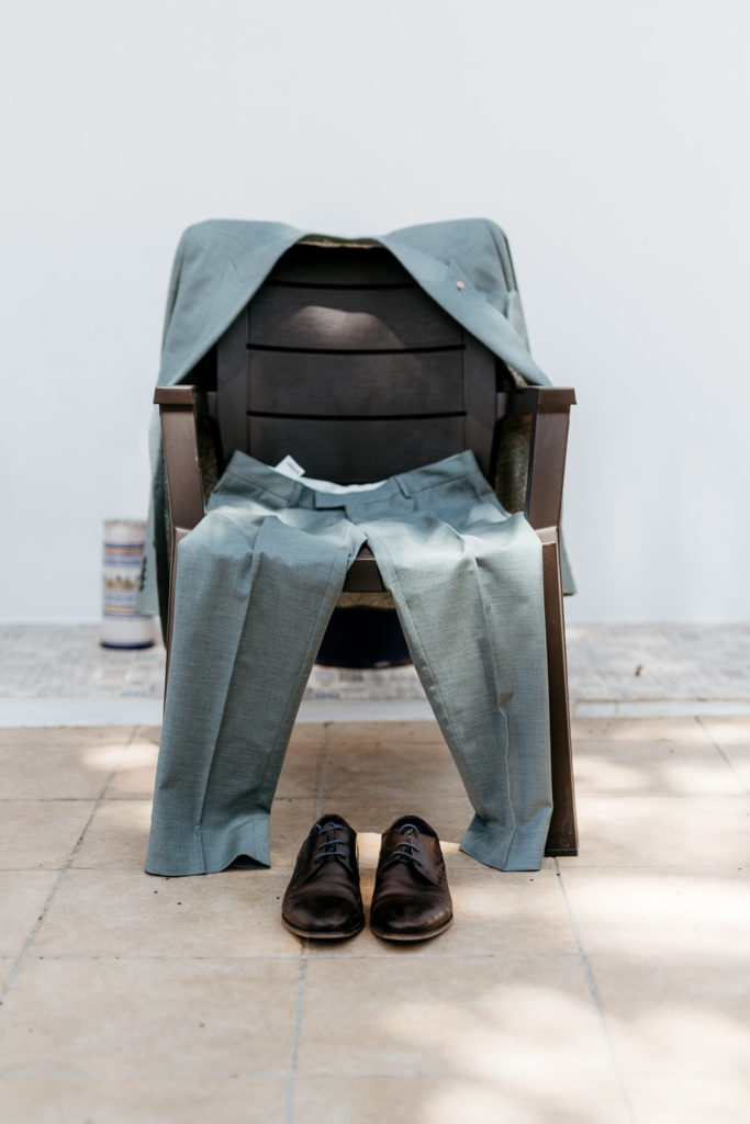 a pair of shoes and pants on a chair