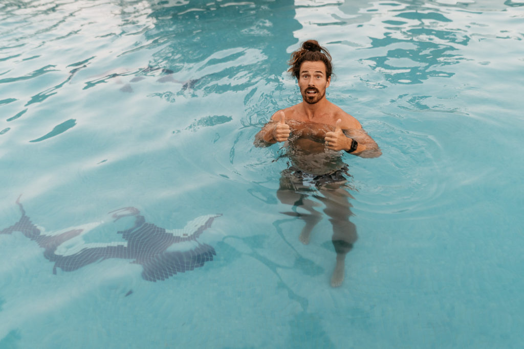 a man in a pool giving thumbs up