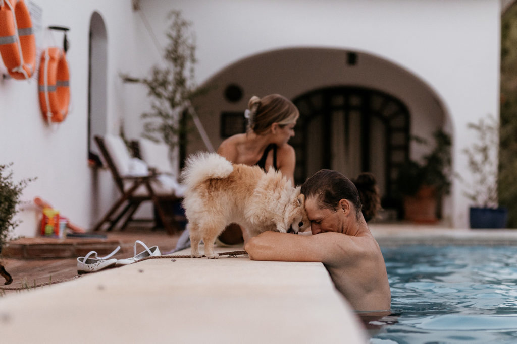 a man and dog in a pool